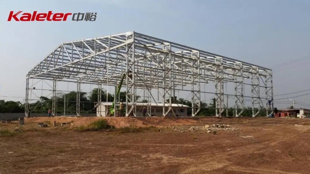 Steel-structure poultry house frame under construction with Kaleter logo