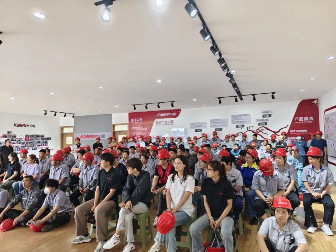 Kaleter employees in red safety helmets attending a safety training session