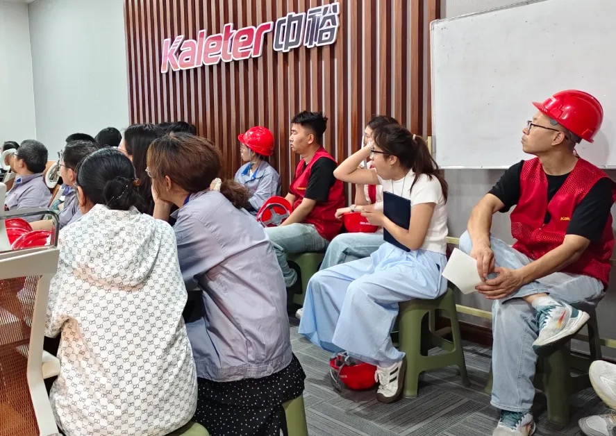 Kaleter employees in a training session wearing red safety helmets